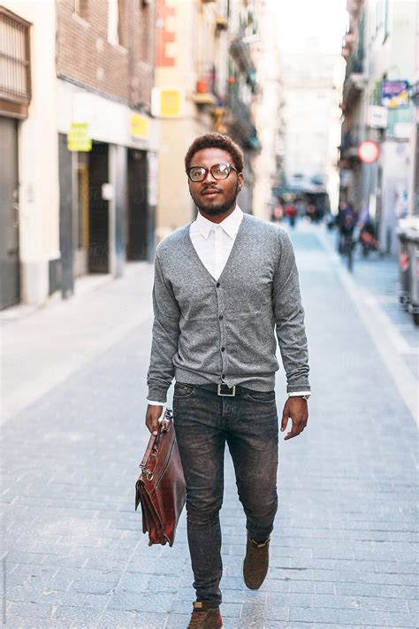 Black Man Walking With Briefcase On Barcelona Streets By Stocksy