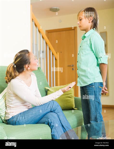 Adult Mother Scolding Naughty Teenage Son In Living Room At Home Stock