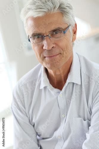 Portrait Of Senior Man With Grey Hair Wearing Eyeglasses Stock Photo