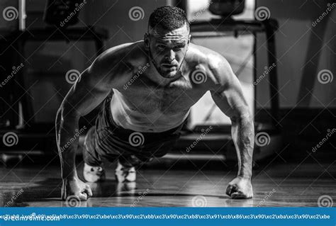 Muscular Man Doing Push Ups On One Hand Against Gym Background Man