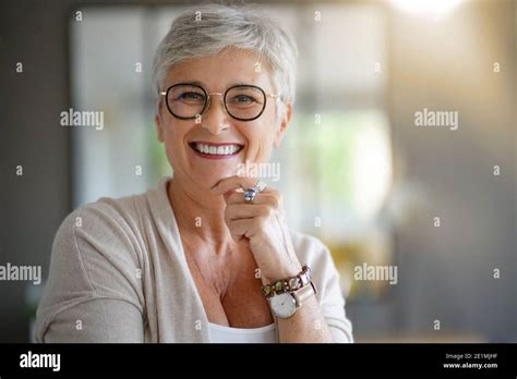Portrait Of A Beautiful Smiling 55 Year Old Woman With White Hair Stock