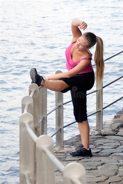 Woman In Sportswear Outdoors Stretching Her Legs Before Running Stock Image Image Of