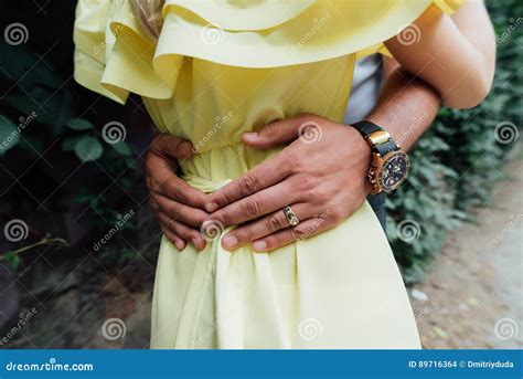 Man S Hands On The Waist Of A Girl In Yellow Dress Man Holds His Hands
