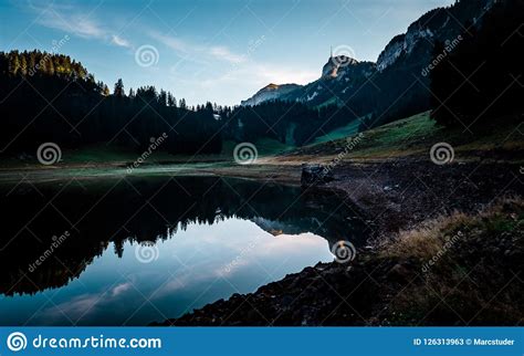 Amazing Water Reflection In Clear Moutain Lake During Sunrise Morning