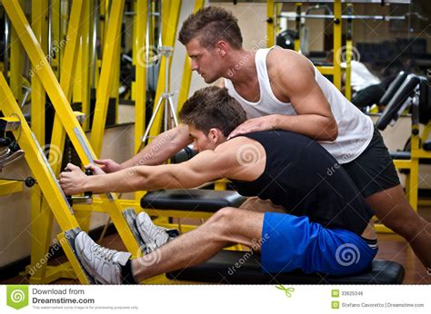 Trainer Helping Woman Do Sit Ups Royalty Free Stock Image