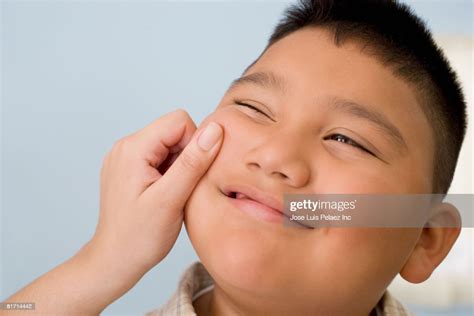 Hispanic Boy Having Cheek Pinched High Res Stock Photo Getty Images
