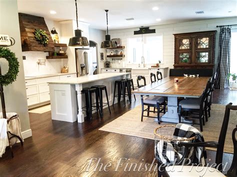 An Open Kitchen And Dining Room With Wood Flooring