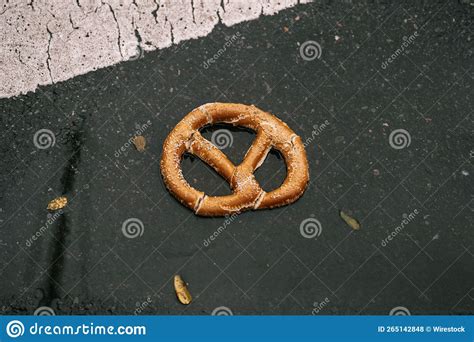 Broken Pretzel On A Black Surface On The Ground Stock Photo Image Of