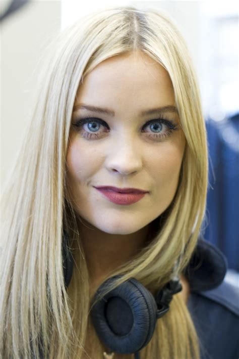a woman with long blonde hair wearing headphones