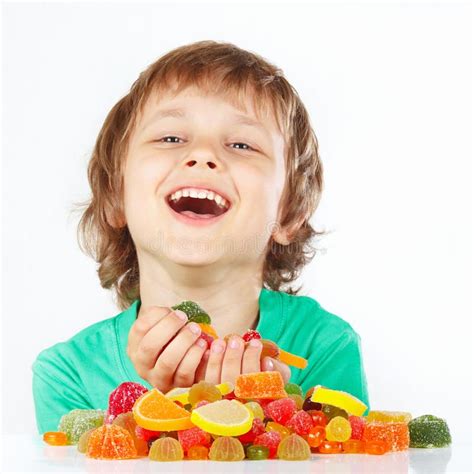 Smiling Child With Sweets And Candies On White Background Stock Image