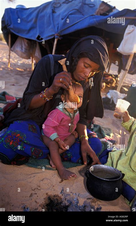 Niger Ifrouane Mother Of Tuareg Tribe Feeding Child Stock Photo Alamy