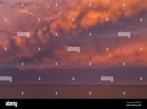 Storms Clouds Over The Ocean During Golden Hour With Drilling Rig On