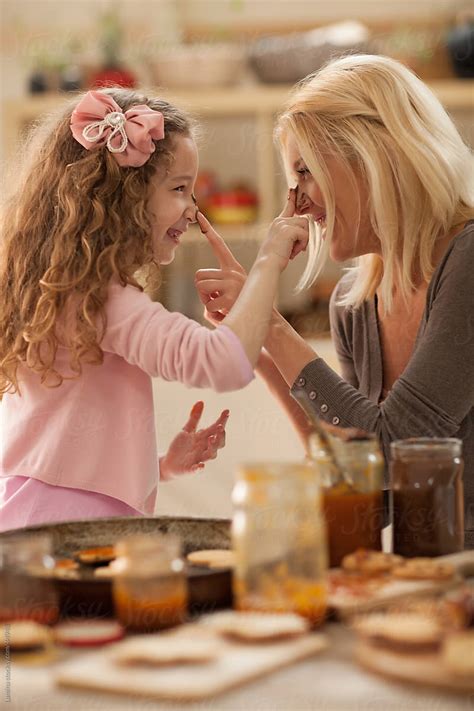 Mother And Daughter Making Cookies By Lumina