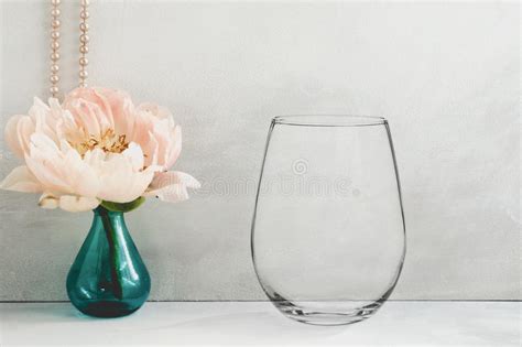 Mockup Stemless Wine Glass Next To A Peony In A Vase