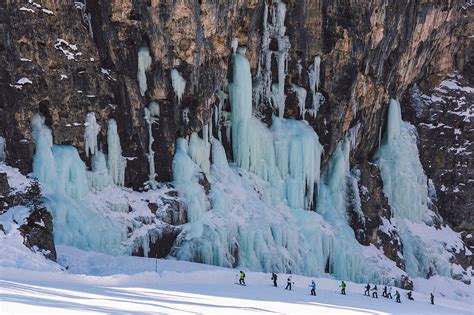 Skiers Underneath The Frozen Waterfall License Image 71078764