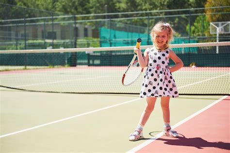Free Photo Cute Little Girl Playing Tennis On The Tennis Court Outside