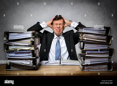 Overworked Stressed Businessman With Lot Of Files On His Desk Stock