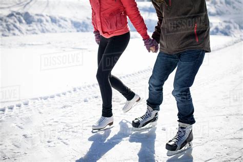 Caucasian Couple Ice Skating On Snowy Frozen Lake Stock Photo Dissolve