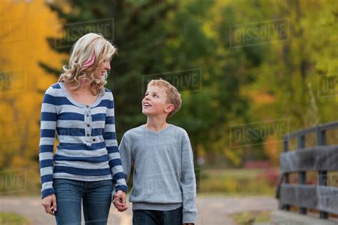 Mother And Son Walking And Talking In A Park In Autumn Free Download