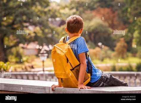 Sad Alone Boy Sitting In The Park Outdoors Stock Photo Alamy