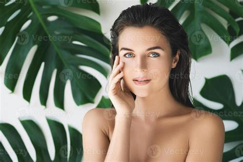 Portrait Of Young And Beautiful Woman With Perfect Smooth Skin In Tropical Leaves 16200208 Stock