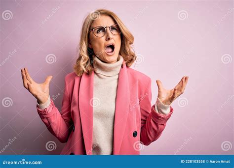 Middle Age Beautiful Blonde Business Woman Wearing Elegant Pink Jacket And Glasses Crazy And Mad