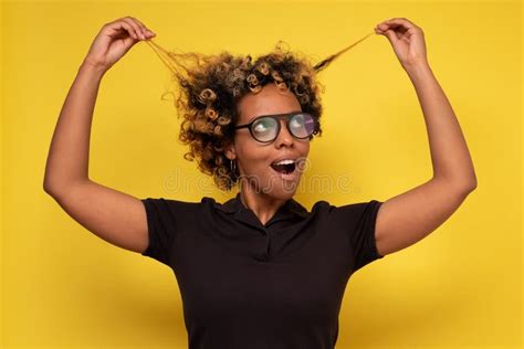 Beautiful African American Woman Looking At Her Curly Hair Stock Image
