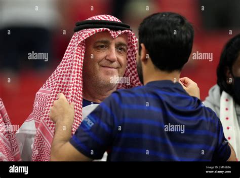 A Fan Of England Has His Shemagh Adjusted By A Fan Of France In The