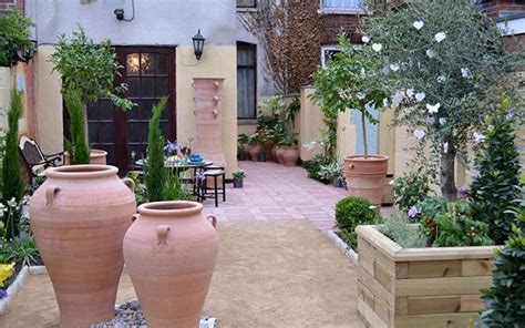 Mediterranean Garden With Terracotta Pots And Outdoor Furniture