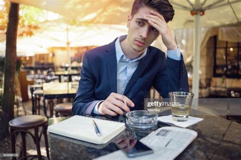 Depressed Welldressed Man Smoking And Drinking Alcohol High Res Stock