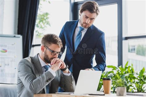 Two Concentrated Businessmen Working Together Stock Photo Image Of