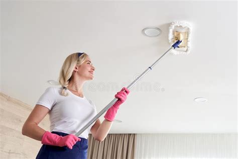 Maid Woman Holding Mop Pile Cleaning Ceiling In Living Room House