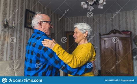 Joyful Active Old Couple Dancing And Laughing In The Living Room