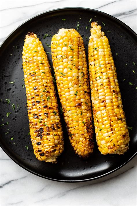 Grilled Corn On The Cob In A Black Plate