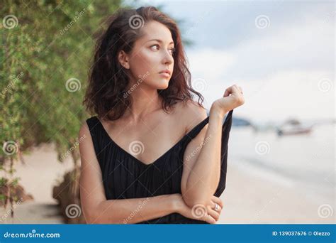 Portrait Of A Beautiful Young Woman With Dark Hair On The Beach Sensual Portrait Natural