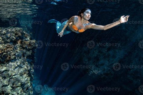 Mermaid Swimming Underwater In The Deep Blue Sea 12188795 Stock Photo