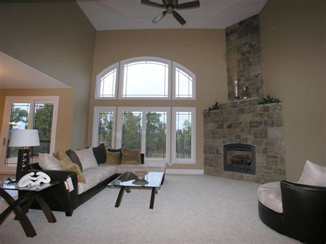 Large corner windows are triangular in shape, making them useful for creating corners between angled windows. living room with high ceilings, large windows, and corner ...