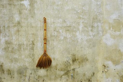 Rustic Handmade Broom Hanging On A Dirty Stucco Wall In Rural Southeast