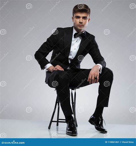 Confident Man Wearing A Black Tuxedo Sitting Stock Image Image Of