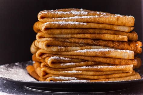 Stack Of Crepes With Powdered Sugar On Dark Background Stock Image