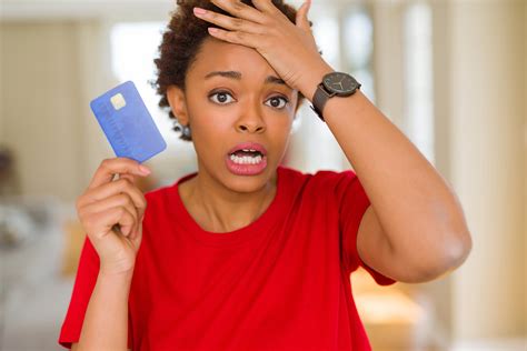 Young African American Woman Holding Credit Card Stressed With Hand On