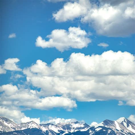 Snow Capped Mountain Under Blue Sky And Clouds Stock Photo Image Of