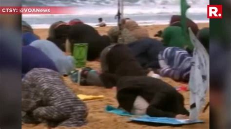 Climate Change Activists Bury Their Heads In The Sand To Protest