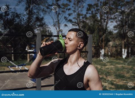 Tired Athlete Man Drinking Water From Sport Shaker After Fitness