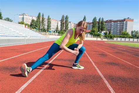 Premium Photo The Girl Is Warming Up At The Stadium Sportswoman