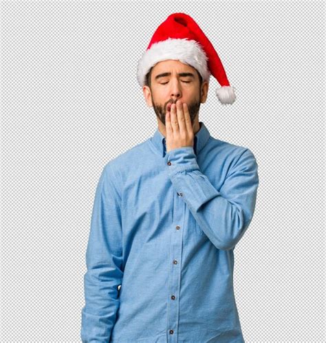 Premium Psd Young Man Wearing Santa Hat Tired And Very Sleepy