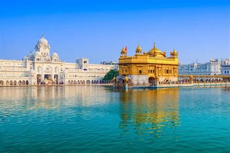 The Golden Temple Is Surrounded By Blue Water