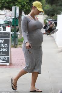 Amber Rose Displays Her Huge Belly In A Tight Lycra Dress As She Forgoes Her Usual Heavily Made