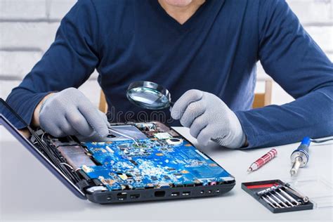 Computer Repairman Repairing The Broken Laptop In The Lab Stock Photo
