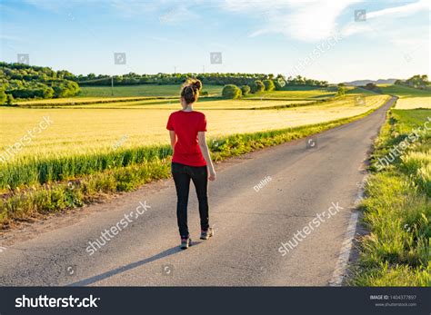 Woman Walking Down Road Light Sunset Stock Photo Shutterstock